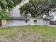 House exterior with a spacious backyard and large tree at 1440 Dann St, Orlando, FL 32804