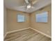 Well-lit bedroom with wood-look floors and two windows with blinds at 1440 Dann St, Orlando, FL 32804