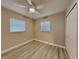 Spacious bedroom featuring two windows, ceiling fan, and wood-like flooring at 1440 Dann St, Orlando, FL 32804