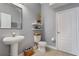 Clean and bright bathroom with pedestal sink and updated toilet at 1473 Broken Oak Dr # C, Winter Garden, FL 34787
