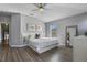 Spacious primary bedroom with large bed, wood floors, and en-suite bathroom at 1473 Broken Oak Dr # C, Winter Garden, FL 34787