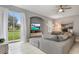 Living room with sectional sofa, sliding glass doors, and backyard access at 1473 Broken Oak Dr # C, Winter Garden, FL 34787