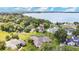 Aerial view of home near lake, highlighting spacious lot and neighborhood at 1556 Auburn Oaks Ct, Auburndale, FL 33823