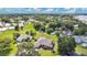 Aerial view of home situated on a large lot with mature trees at 1556 Auburn Oaks Ct, Auburndale, FL 33823