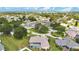 Aerial view of house and neighborhood, showcasing waterfront proximity at 1556 Auburn Oaks Ct, Auburndale, FL 33823