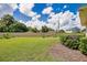 Landscaped backyard with lush lawn and garden at 1556 Auburn Oaks Ct, Auburndale, FL 33823