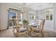 Elegant dining room with a glass-top table, ornate chairs, and a mirrored accent wall at 1556 Auburn Oaks Ct, Auburndale, FL 33823