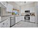 Modern kitchen with white cabinets, stainless steel appliances, and ample counter space at 1556 Auburn Oaks Ct, Auburndale, FL 33823