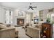Bright living room with fireplace, built-in shelving, and ample natural light at 1556 Auburn Oaks Ct, Auburndale, FL 33823