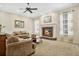Spacious living room featuring a fireplace, comfortable seating, and large windows at 1556 Auburn Oaks Ct, Auburndale, FL 33823