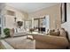 Cozy living room with access to backyard, featuring comfortable seating and a large window at 1556 Auburn Oaks Ct, Auburndale, FL 33823