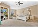Large main bedroom with a king-size bed, plenty of space, and sliding door access to the patio at 1556 Auburn Oaks Ct, Auburndale, FL 33823