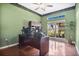 Home office with large window and hardwood floors at 1556 Auburn Oaks Ct, Auburndale, FL 33823