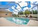 Refreshing screened pool with water feature at 1556 Auburn Oaks Ct, Auburndale, FL 33823