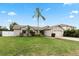 One-story house with a large front yard and palm tree at 1563 Roble Ln, Deltona, FL 32738