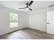 Bright bedroom with wood-look floors and double doors at 22474 Sw Rainbow Lakes Blvd, Dunnellon, FL 34431