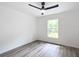 Well-lit bedroom with wood-look floors, window, and ceiling fan at 22474 Sw Rainbow Lakes Blvd, Dunnellon, FL 34431