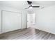 Spacious bedroom with wood-look floors, double doors, and access to another room at 22474 Sw Rainbow Lakes Blvd, Dunnellon, FL 34431