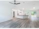 Open concept kitchen with granite countertops, white cabinets, and LVP flooring at 22474 Sw Rainbow Lakes Blvd, Dunnellon, FL 34431