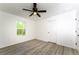 Well-lit bedroom with wood-look floors, ceiling fan and closet at 245 Oak Lane Way, Ocala, FL 34472