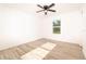 Sunny bedroom with wood-look floors, window, and ceiling fan at 245 Oak Lane Way, Ocala, FL 34472