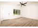 Light-filled living room featuring wood-look floors and large window at 245 Oak Lane Way, Ocala, FL 34472