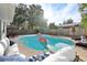 Virtually staged poolside patio with comfortable seating and a flamingo float at 3756 Peaceful Pl, Orlando, FL 32810