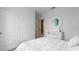 Charming bedroom with a white bed, round mirror, and built-in dresser at 4141 Giorgio Dr, Winter Haven, FL 33884