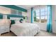 Bedroom with a queen bed, teal accents, and large windows with natural light at 4141 Giorgio Dr, Winter Haven, FL 33884