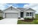 New single-story home with gray siding, two-car garage, and landscaping at 4141 Giorgio Dr, Winter Haven, FL 33884