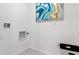 Laundry room with white walls, built-in cabinets, and art at 4141 Giorgio Dr, Winter Haven, FL 33884