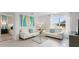 Open living area with white sofas, a glass coffee table, and a view of a bedroom at 4141 Giorgio Dr, Winter Haven, FL 33884