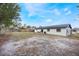 Spacious backyard with a large grassy area and patio at 4856 Victory Dr, Orlando, FL 32808