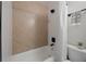 Clean bathroom with a herringbone tiled shower/tub at 4856 Victory Dr, Orlando, FL 32808