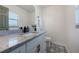 Bathroom boasts granite countertop, white cabinets, and patterned floor at 4856 Victory Dr, Orlando, FL 32808