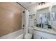 Bathroom with herringbone tile and white bathtub at 4856 Victory Dr, Orlando, FL 32808