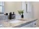 Modern bathroom vanity with granite countertop and black fixtures at 4856 Victory Dr, Orlando, FL 32808
