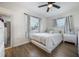 Bright bedroom with a queen-size bed, two windows, and light wood floors at 4856 Victory Dr, Orlando, FL 32808