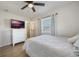Bedroom with a queen bed, TV, and ceiling fan at 4856 Victory Dr, Orlando, FL 32808