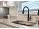 Modern kitchen sink with black faucet and granite countertop at 4856 Victory Dr, Orlando, FL 32808