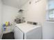 Clean laundry room, featuring a washer and dryer, and storage at 4856 Victory Dr, Orlando, FL 32808