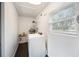 Bright laundry room with washer, dryer, and ample shelving at 4856 Victory Dr, Orlando, FL 32808