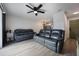 Spacious living room with gray reclining sofas and ceiling fan at 4856 Victory Dr, Orlando, FL 32808