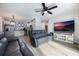 Open living room featuring gray leather sofas, a large TV, and access to the backyard at 4856 Victory Dr, Orlando, FL 32808