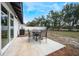 Concrete patio with table and chairs, overlooks the backyard at 4856 Victory Dr, Orlando, FL 32808