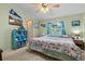 Comfortable bedroom with a queen-size bed and built-in shelving at 6399 Lolly Bay Ne Loop, Winter Haven, FL 33881