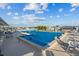 Community pool with lounge chairs and blue cover at 6399 Lolly Bay Ne Loop, Winter Haven, FL 33881