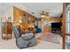 Living room with wood paneling, comfortable seating, and built-in shelving at 6399 Lolly Bay Ne Loop, Winter Haven, FL 33881