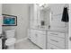 Elegant bathroom with double vanity, white cabinets, and tiled floors at 16028 Trivoli Cir, Bella Collina, FL 34756