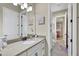 Bathroom has a granite countertop, white cabinets, and a view of a bedroom at 3875 Grassland Loop, Lake Mary, FL 32746